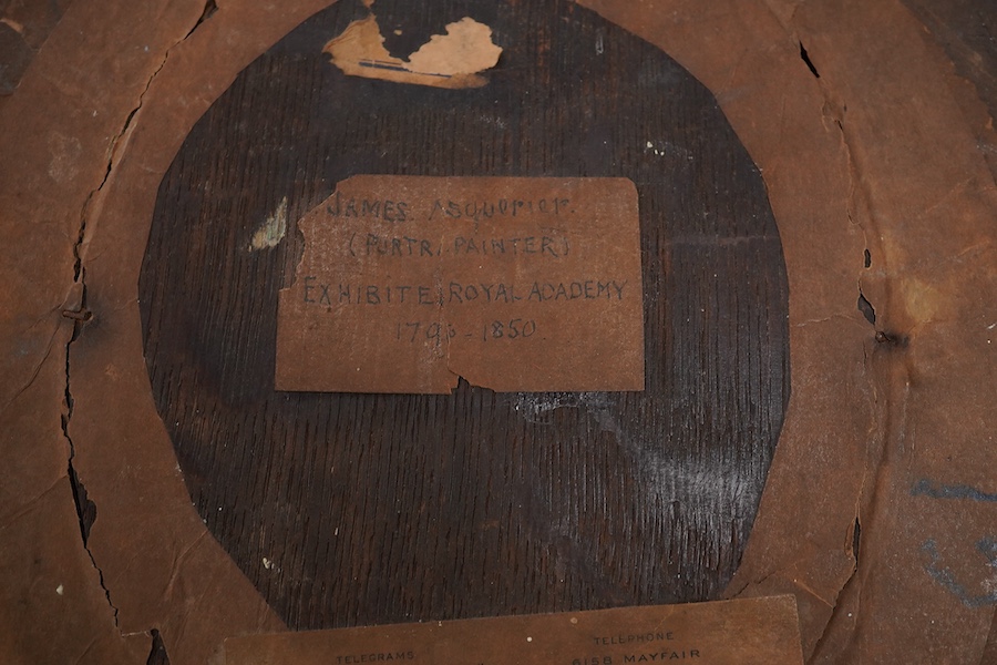Attributed to John James Masquerier (1778-1855), portrait of a young girl holding a tabby cat, Arthur Ackermann label and ink inscription verso, oval oil, 15.5 x 12.5cm